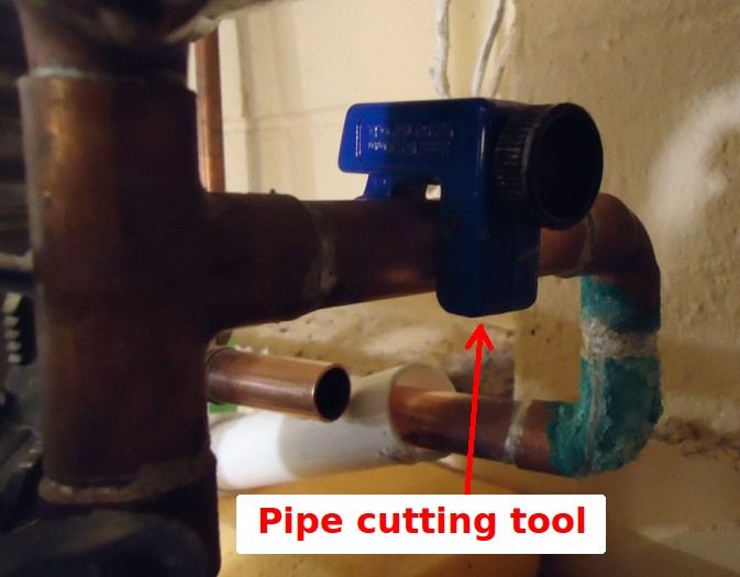 A tube cutter on copper pipe